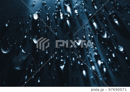 Round drops of water on dark background. Through transparent drops of water pass rays of light. View Round drops of water on dark background. Through transparent drops of water pass rays of light. View 97690071
