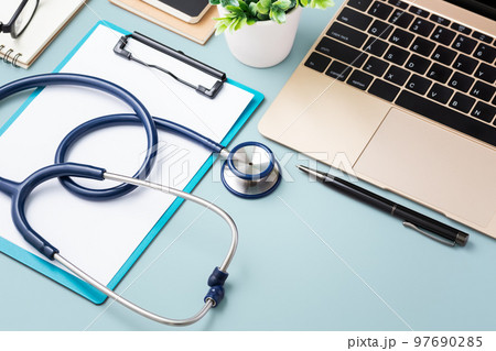 Doctor desk with medical stethoscope and laptop 97690285