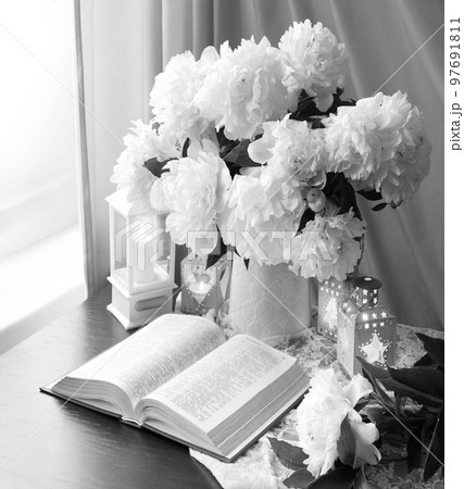 Still life. Open book and bouquet of flowers 97691811