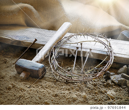 Rusty nails and a wreath of thorns at the cross 97691844