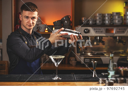 Professional bartender mixing a cocktail Professional bartender mixing a cocktail 97692745