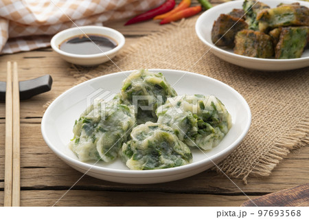 Chinese Chive Dumplings,Steamed Dumpling stuffed with Garlic Chives on white plate with sauce Chinese Chive Dumplings,Steamed Dumpling stuffed with Garlic Chives on white plate with sauce 97693568