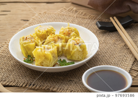 Shumai or Chinese Steamed Dumpling,meatball dumpling with wanton skin in with plate,served with soy sauce Shumai or Chinese Steamed Dumpling,meatball dumpling with wanton skin in with plate,served with soy sauce 97693586