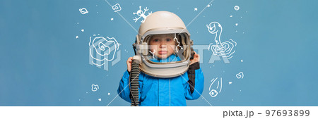 Creative design with drawn elements. Portrait of little boy, child in costume of astronaut over blue background. Feeling sad 97693899