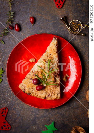 A piece of grated walnut cake with cranberries A piece of grated walnut cake with cranberries 97700810