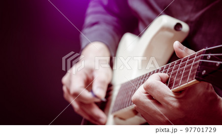 close up musician hands playing white electric guitar. music background close up musician hands playing white electric guitar. music background 97701729