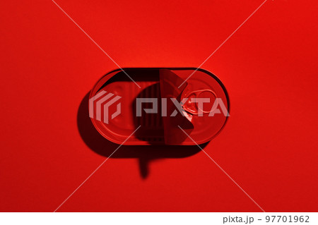 Dark red tin can on red background 97701962