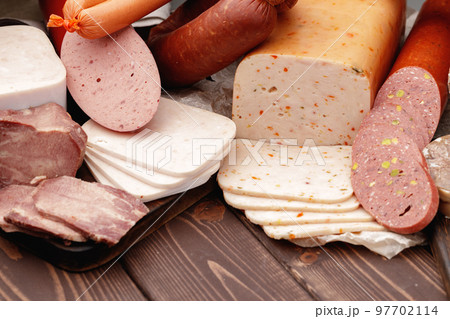 Variety of meat and sausage products on table 97702114