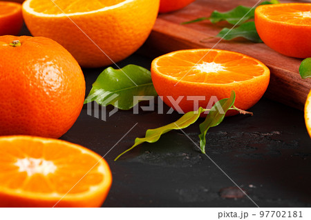 Cut oranges on wooden board on table Cut oranges on wooden board on table 97702181