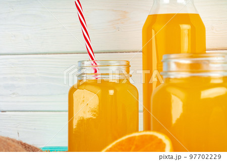 Close up of orange juice glass on wooden table Close up of orange juice glass on wooden table 97702229