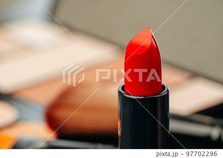 New red lipstick on vanity table close up 97702296