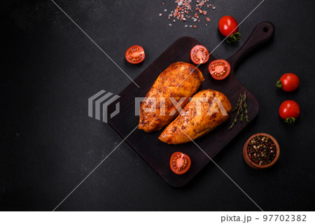 Delicious grilled chicken fillet with spices and herbs Delicious grilled chicken fillet with spices and herbs 97702382