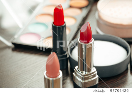 Pink and red lipsticks on vanity table Pink and red lipsticks on vanity table 97702426