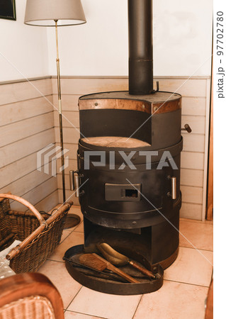 Old potbelly stove in a French house Old potbelly stove in a French house 97702780