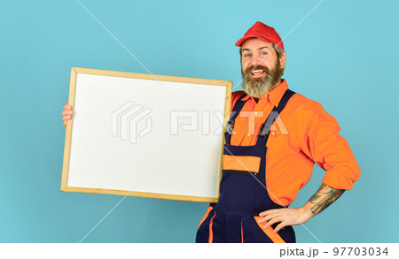 Builder men points on flipchart. Engineer project, copy space. architect and engineering drawing. contractor giving presentation. Presentation on flipchart plan for construction 97703034