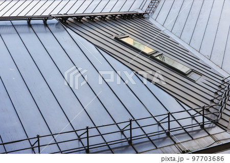 Shiny metal roof with railings and attic windows, modern architecture 97703686