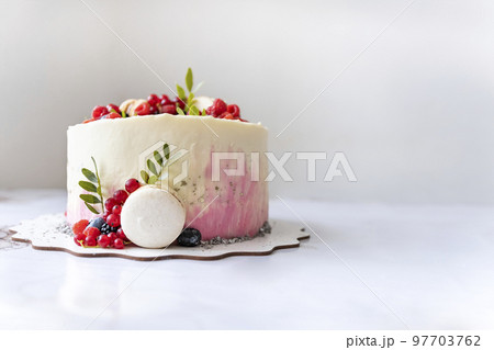 Summer fruit cake with decoration of berries and macaroon. Holiday or birthday pastry. Dessert with berries. Copy space 97703762