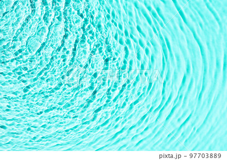Turquoise water texture background, water surface with sun rays reflection, high resolution. 97703889
