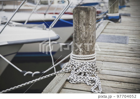 Wooden post for mooring yachts on the pier in Denmark Wooden post for mooring yachts on the pier in Denmark 97704052