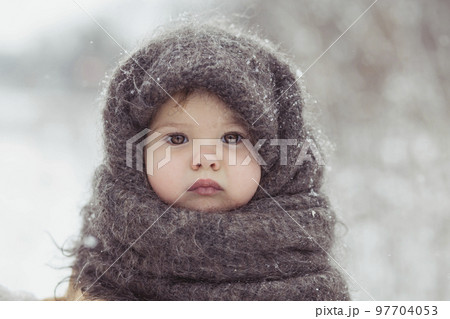 Retro photo of adorable baby in a woolen shawl in winter Retro photo of adorable baby in a woolen shawl in winter 97704053
