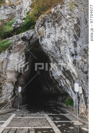 Karst cave entrance Postojnska-Jama in Slovenia 97704077