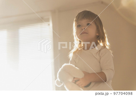 charming blonde baby with a toy in the morning charming blonde baby with a toy in the morning 97704098