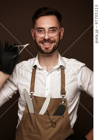 Manicur master man in working form with tools in hand. Nail photo content Manicur master man in working form with tools in hand. Nail photo content 97705113