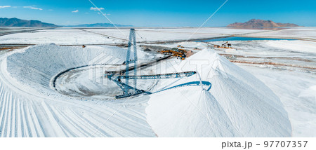 Salt Lake City, Utah landscape with desert salt mining factory at lake Bonneville with piles of white mineral and industrial equipment 97707357