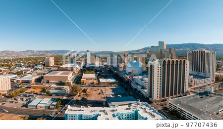 Panoramic aerial view of the city of Reno cityscape in Nevada. Downtown Reno, Nevada, with hotels, casinos and the surrounding High Eastern Sierra foothills. Panoramic aerial view of the city of Reno cityscape in Nevada. Downtown Reno, Nevada, with hotels, casinos and the surrounding High Eastern Sierra foothills. 97707436