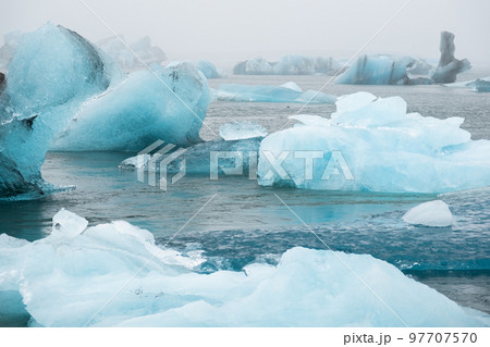 Iceland Lake with Melting Glaciers in Foggy Weather, Pure Blue Ice in Jokulsarlon lagoon. 97707570