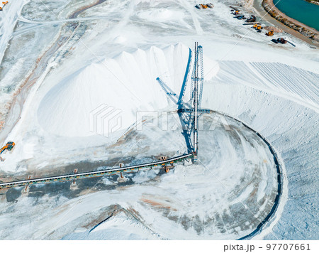Salt Lake City, Utah landscape with desert salt mining factory at lake Bonneville with piles of white mineral and industrial equipment Salt Lake City, Utah landscape with desert salt mining factory at lake Bonneville with piles of white mineral and industrial equipment 97707661