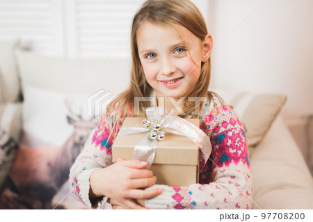 Portrait of cute little beautiful girl with gift box 97708200