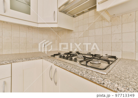 Interior of empty white kitchen with windows and wooden parquet floor 97713349