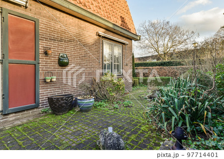 Neat patio with sNeat paved patio with sitting area and small garden near wooden fenceitting area 97714401
