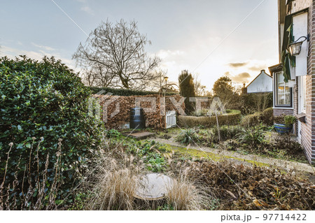 Neat patio with sNeat paved patio with sitting area and small garden near wooden fenceitting area 97714422