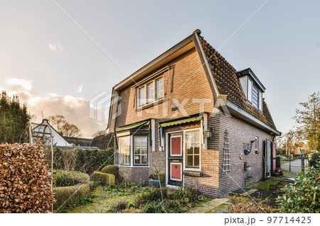 Neat patio with sNeat paved patio with sitting area and small garden near wooden fenceitting area 97714425