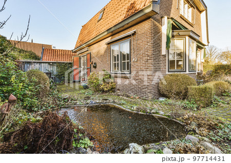 Neat patio with sNeat paved patio with sitting area and small garden near wooden fenceitting area 97714431