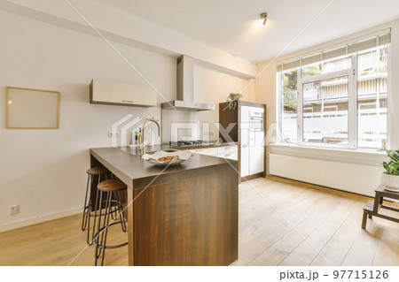 a kitchen and dining area in a house with white walls, hardwood flooring and large windows overlooking out onto the street a kitchen and dining area in a house with white walls, hardwood flooring and large windows overlooking out onto the street 97715126