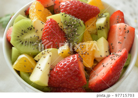 Bowl of fresh fruit salad, kiwi, apples, oranges 97715703
