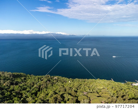 Aerial sea clouds. Panoramic view of seascape with crystal clear azure sea. Yachts in a beautiful lagoon on backdrop of rocks. The concept of an ideal destination for summer travel and vacation. Aerial sea clouds. Panoramic view of seascape with crystal clear azure sea. Yachts in a beautiful lagoon on backdrop of rocks. The concept of an ideal destination for summer travel and vacation. 97717204