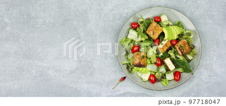 Salad of frying tofu and fresh vegetables. 97718047