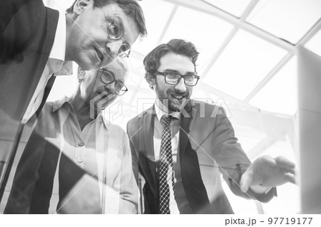 close up. business lady and her colleagues standing near the office Desk. close up. business lady and her colleagues standing near the office Desk. 97719177