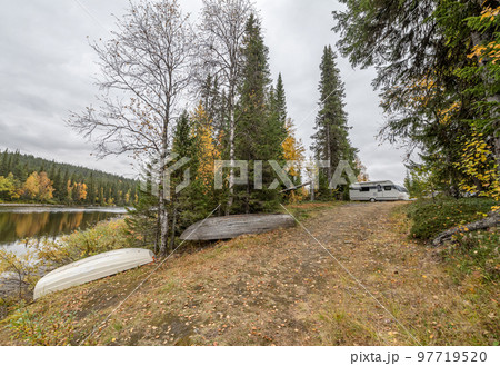 camping caravan near river autumn fall landscape along Ammarnas National Park in Lapland Sweden camping caravan near river autumn fall landscape along Ammarnas National Park in Lapland Sweden 97719520