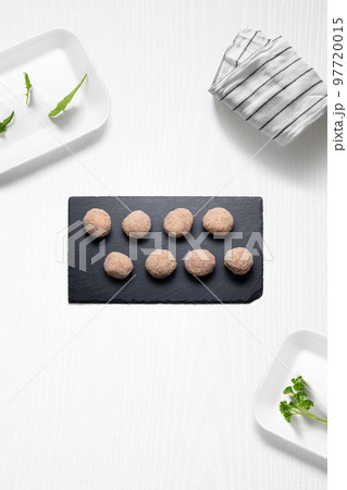Meatballs on a kitchen with some herbs 97720015