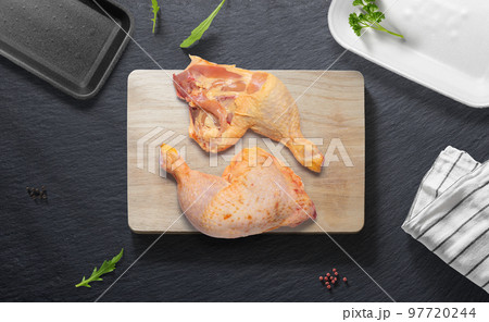 Chicken thighs on a flat lay of a kitchen with various items Chicken thighs on a flat lay of a kitchen with various items 97720244