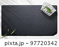 Empty slate board on a flat lay of a kitchen with various items 97720342
