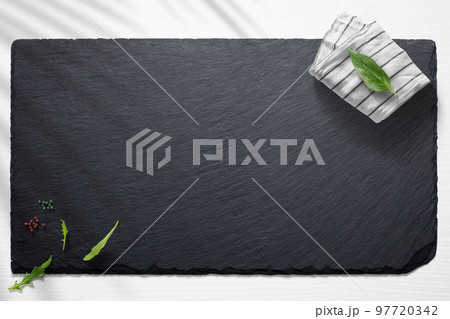 Empty slate board on a flat lay of a kitchen with various items 97720342