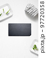 Flat lay of a kitchen with a slate plate and herbs 97720358