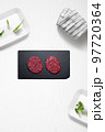 Beef burguers on a kitchen with some herbs 97720364