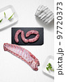Criollo chorizo and pork ribs on a kitchen with some herbs 97720373